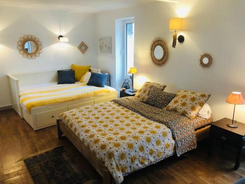 une chambre avec deux lits et un canapé dans l'établissement Maison de famille avec piscine Au Coucou chanteur, à Goûts-Rossignols