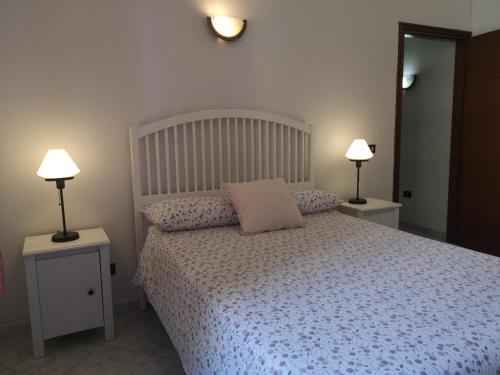 a bedroom with a bed with a pink pillow on it at Dormire a Roma in Rome