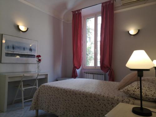 a bedroom with a bed and a desk and a window at Dormire a Roma in Rome