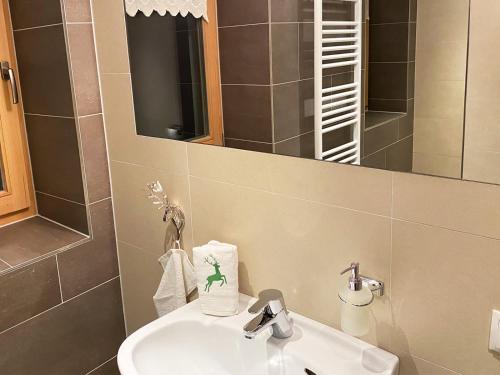 a bathroom with a sink and a mirror at Alpenfarm Poschhof in Kaunerberg