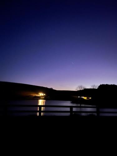 a view of a body of water at night at East Learmouth Lakeside Lodges - Larch Lodge in Cornhill-on-tweed