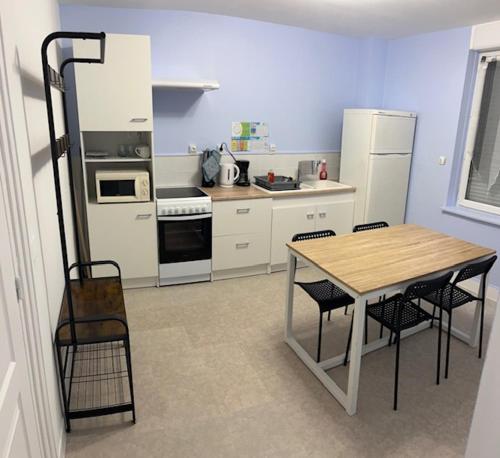 a kitchen with a table and chairs in a kitchen at Gite for you muguet in Neuvy-sur-Loire