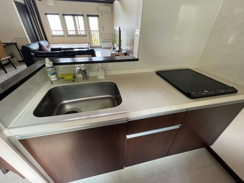 a kitchen with a sink and a counter top at Chalet Fuyuri in Furano