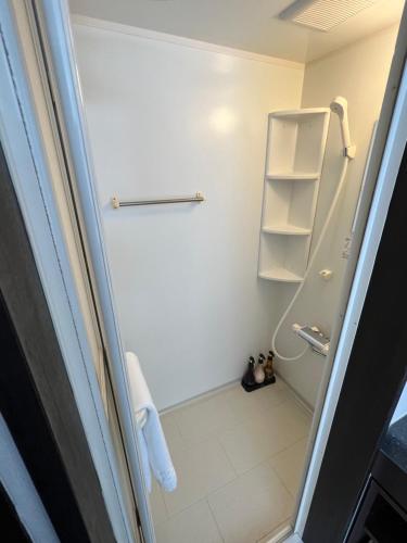 a small bathroom with a shower and a toilet at Chalet Fuyuri in Furano