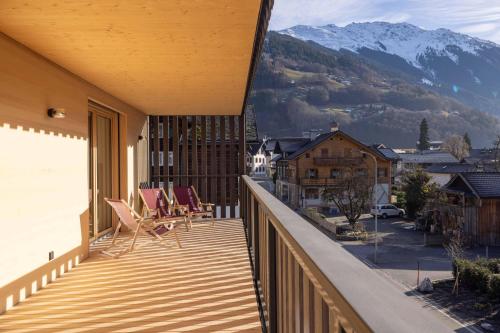 a balcony with chairs and a view of a mountain at Apartmenthaus A24 in Schruns