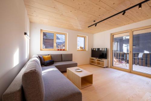 a living room with a couch and a tv at Apartmenthaus A24 in Schruns