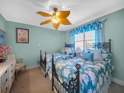 a blue bedroom with a bed and a ceiling fan at Arcadian Getaway - Oceanfront Condo, With Pool and Wifi, Monthly Winter Rental in Myrtle Beach