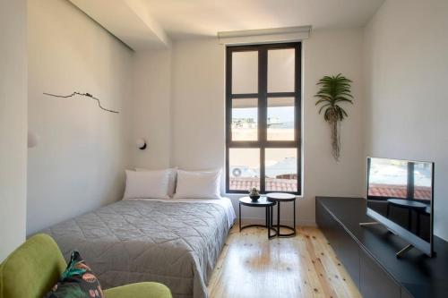 a bedroom with a bed and a window at Hoppersgr- Amazing apt in the heart of Athens - 5 in Athens