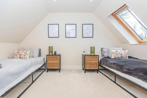 a attic room with two beds and a window at The Gate House - 3 Bed & Parking in Edinburgh