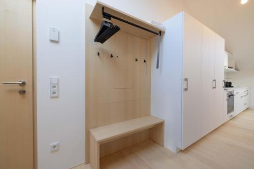 a room with a closet with a bench next to a door at Apartmenthaus A24 in Schruns-Tschagguns