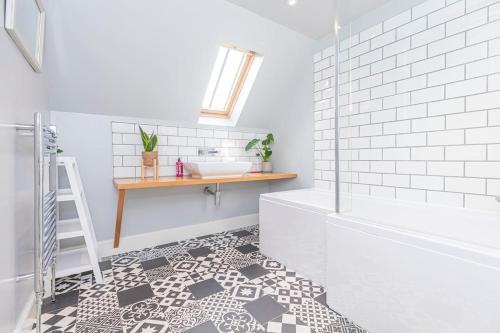 La salle de bains est pourvue d'une douche, d'un lavabo et d'un comptoir. dans l'établissement The Gate House - 3 Bed & Parking, à Édimbourg