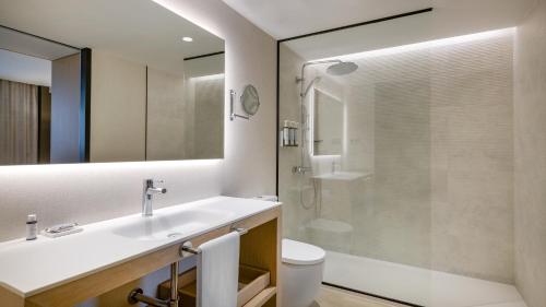 a bathroom with a sink and a shower and a toilet at AC Hotel Victoria Suites by Marriott in Barcelona