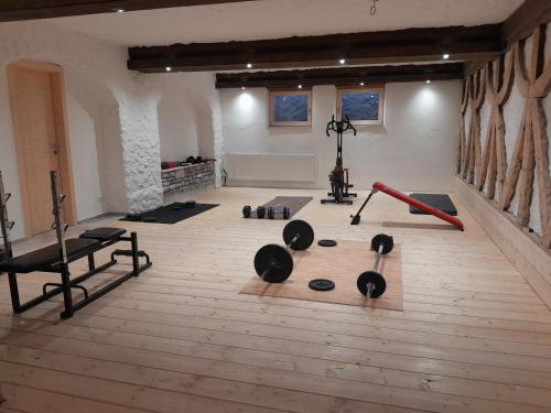 a gym with dumbbells and weights in a room at Gästehaus Zunterer in Wallgau
