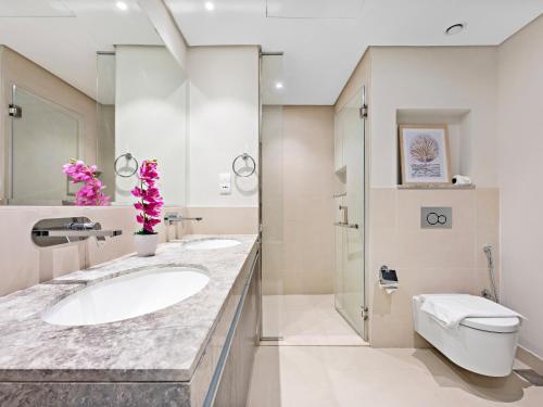 a bathroom with a sink and a toilet at Brand New Spacious 2BDR Dubai Creek Residences - South in Dubai