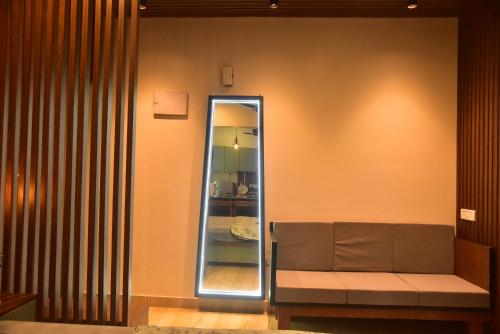 a mirror on a wall next to a bench at UnigoOne- Prime in Canacona