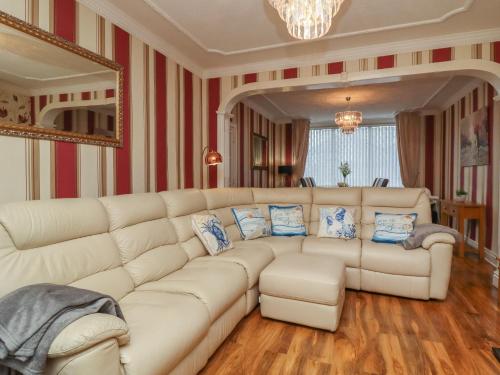 a living room with a large white couch at 19 Slinger Road in Cleveleys