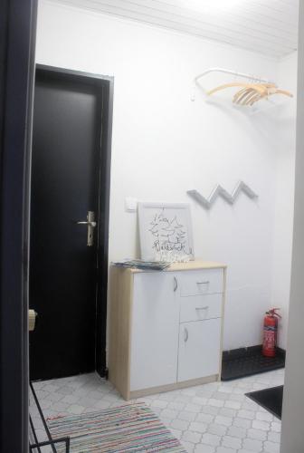 a room with a black door and a white cabinet at Haus Waldblick in Philippsreut