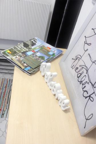 a table with a game controller next to a book at Haus Waldblick in Philippsreut