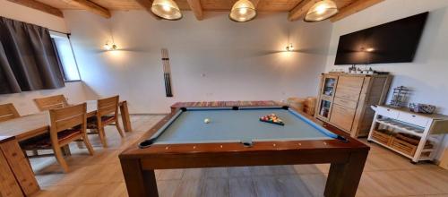 a living room with a pool table and a tv at Penzion Na Bělisku in Březiny