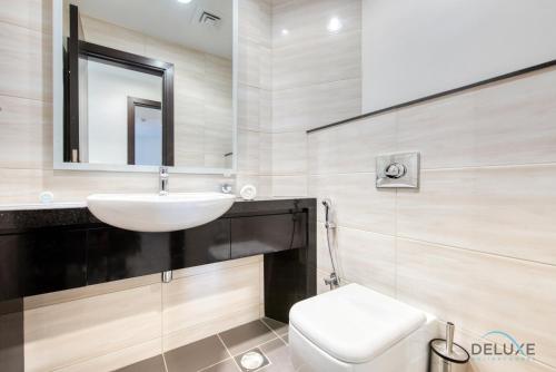 a bathroom with a sink and a toilet at Cordial 1BR at Celestia B Dubai South by Deluxe Holiday Homes in Dubai