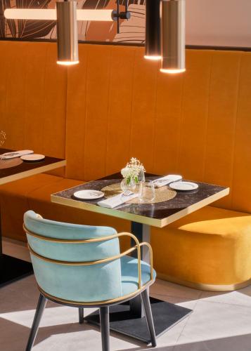 a dining room with a table and a chair at Barceló Fortina Malta in Sliema