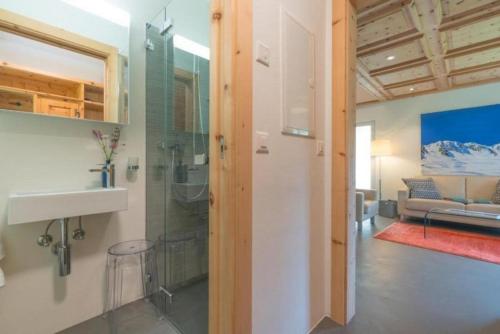 a bathroom with a shower and a sink in a room at Chesa Lagrev 1 in Sils Maria