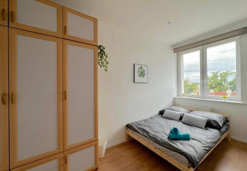 a bedroom with a bed and a large window at Quill Room in Gdynia