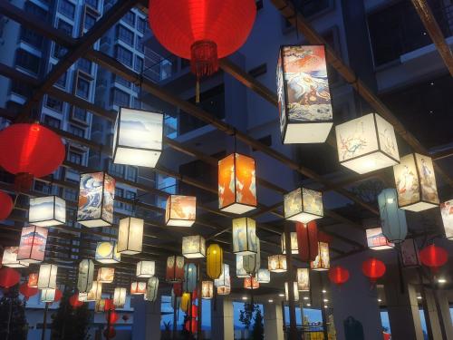 a bunch of chinese lanterns hanging from a ceiling at K AVENUE B17 house room near airport by Gc in Kota Kinabalu