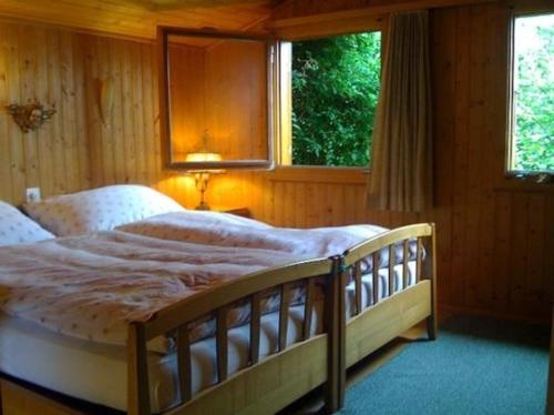 a bedroom with a large bed in front of a window at Ferienhaus in Quinten-Au in Quinten