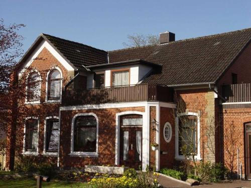 a brown brick house with a black roof at Ferienhof Jens Ferienwohnung 4 in Kronsgaard