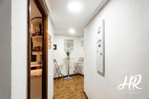 a hallway with a table and chairs in a room at HR-Madrid-Puerta del Sol in Madrid