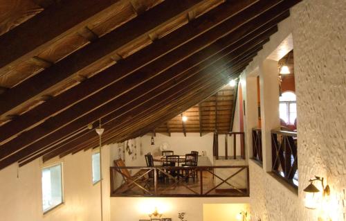 a room with a dining room with wooden beams at The Thota Mane - Private Villa in Coffee Estate in Sakleshpur