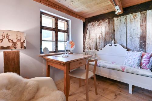 a room with a desk and a bed and a window at Voglen 2 in Nesselwang