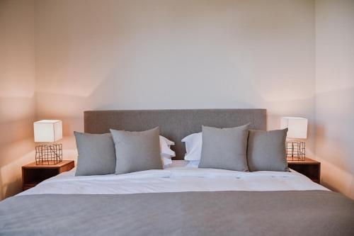 a bedroom with a large bed with two lamps at Vila Natura IV in Opatija