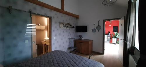 una camera con un letto e una porta che conduce a un corridoio di Au Chat'rme des Blanches Pierres a Francorchamps