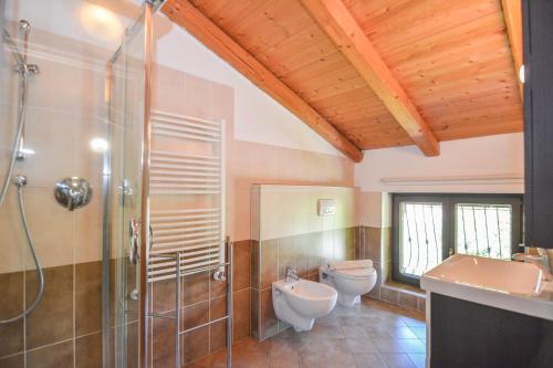 a bathroom with two toilets and a shower at Agritur Airone Bed & Camping in Levico Terme