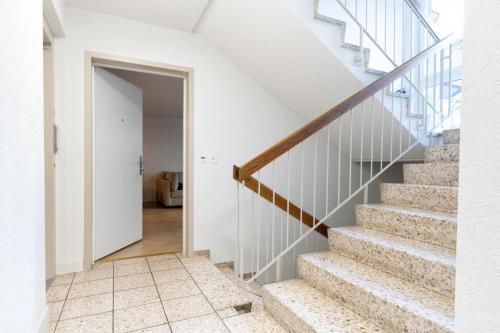 a staircase in a house with white walls and a door at Ground floor apartment - Peaceful living in the city of Zürich in Zürich