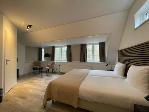 Ένα ή περισσότερα κρεβάτια σε δωμάτιο στο Hotel Randduin