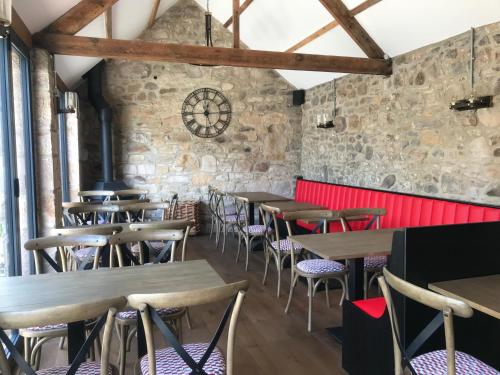 an empty restaurant with wooden tables and chairs at Star Cottage - Harbottle - Nr Rothbury - Northumberland in Morpeth