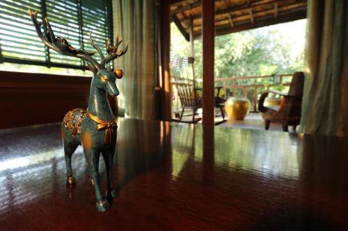 a figurine of a reindeer sitting on a table at Devi Kampot Resort at Phum Kampot in Kampot