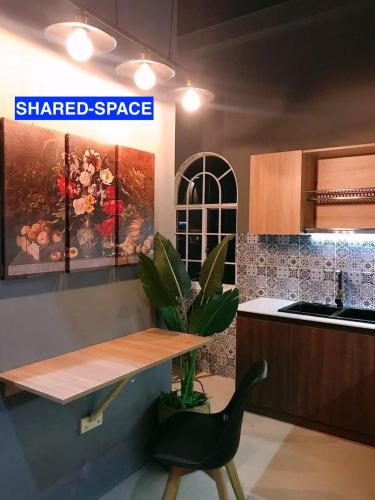a kitchen with a table and a black chair at Nhà Yên 1 Bed 2 Beds Hotel Homestay Hostel Cần Thơ in Can Tho