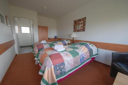 Cama o camas de una habitación en Hotel Breidavik