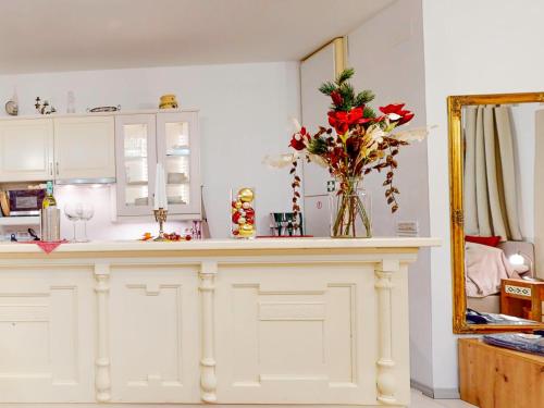 a kitchen with a counter with a vase of flowers at Apartment Michaela 4-Sterne & Parking in Rovinj