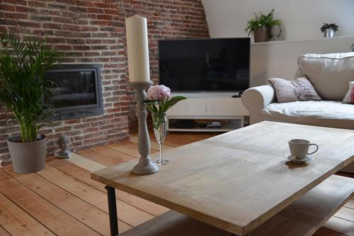 a living room with a wooden table and a fireplace at Appartbrussels in Brussels