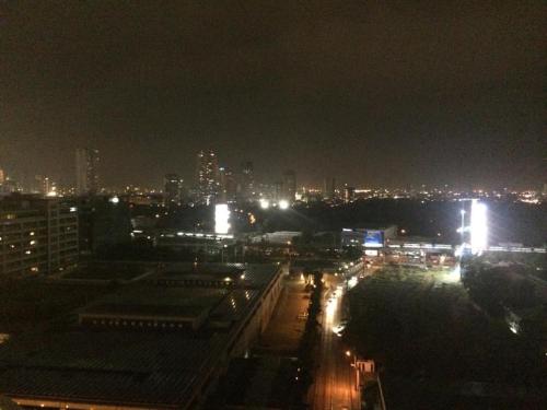 a night view of a city with lights at Cozy 54 sqm one bedroom unit with 400 mbps WI-FI and sunset skyline view in Manila