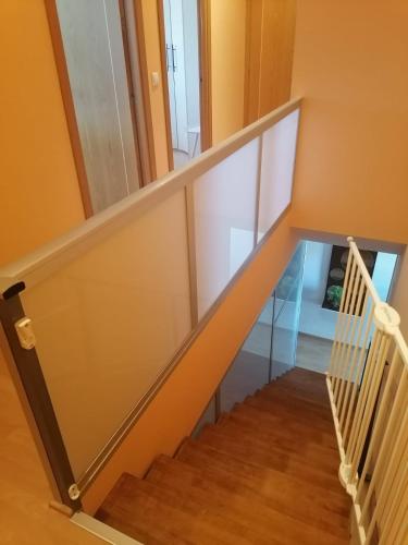 a staircase in a house with a glass wall at El Vergel del Piedra in Munébrega
