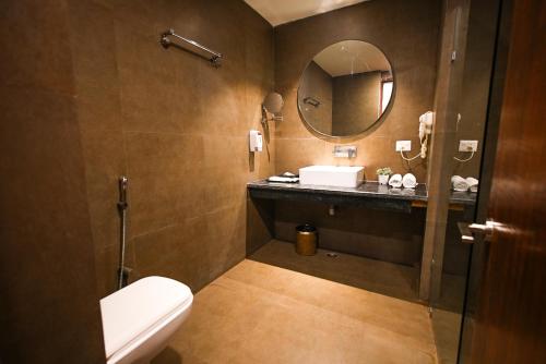 a bathroom with a toilet and a sink and a mirror at Dazzling in Agra