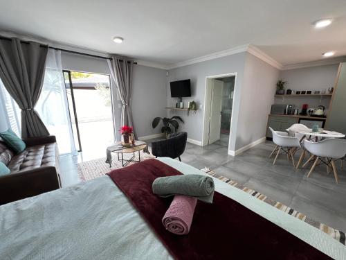 una camera con letto e un soggiorno di Afrique134 Olive Tree Private Courtyard Suite a Pretoria