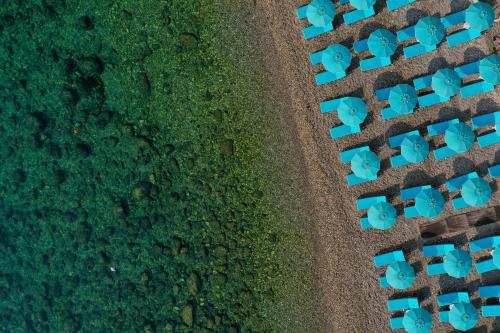 an overhead view of a park with blue chairs at La Plage Resort in Taormina
