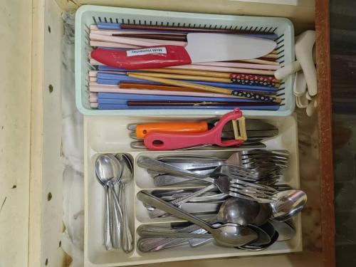 a drawer full of utensils in a container at AaronL Homestay in Kota Kinabalu